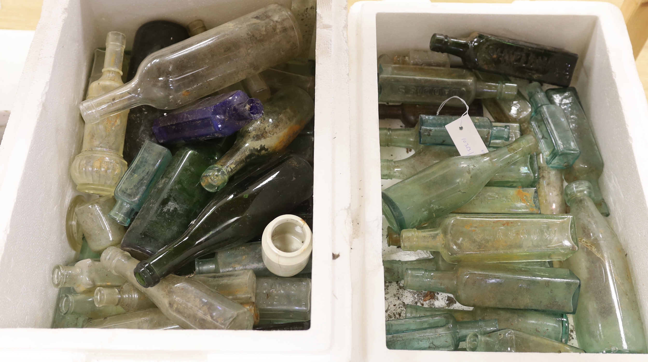 A large collection of excavated glass bottles, together with Oxo jars etc, the largest 29cm high